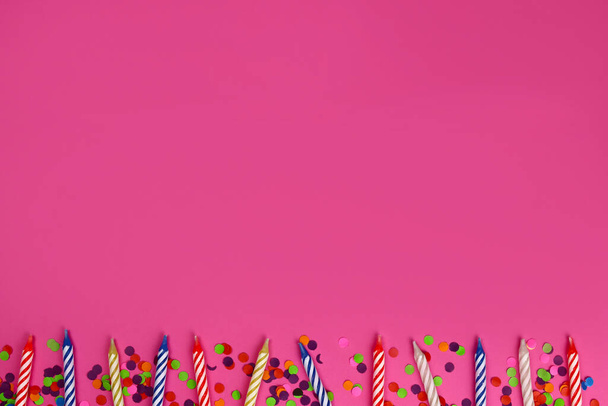 ряд красочных свечей дня рождения на розовом фоне. Праздничная вечеринка - Фото, изображение