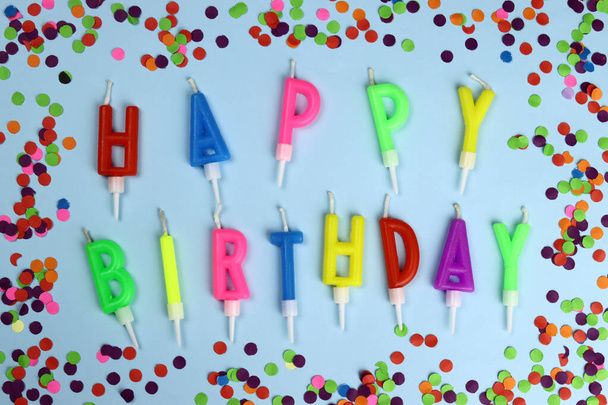 Colorful happy birthday candles on a blue background - Zdjęcie, obraz