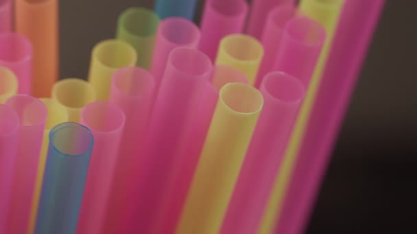 Multicolored straws for drinks, close-up, camera movement, dark background - Footage, Video