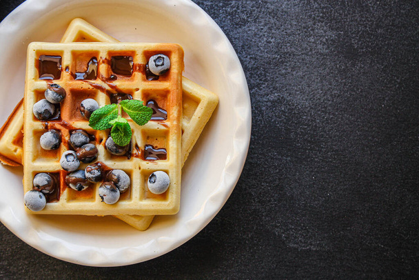 belgium waffles with blueberries and mint leaves - 写真・画像