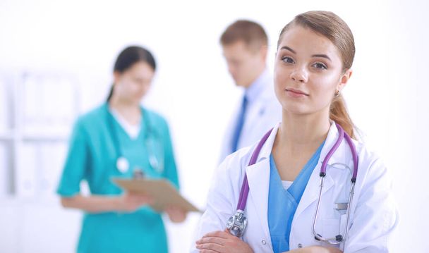 Attractive female doctor in front of medical group. - Photo, image