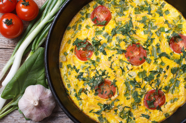 Frittata in a frying pan, and the ingredients on the table  - Photo, Image