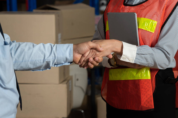 Warehouse worker handshake with manager in storehouse - Photo, Image