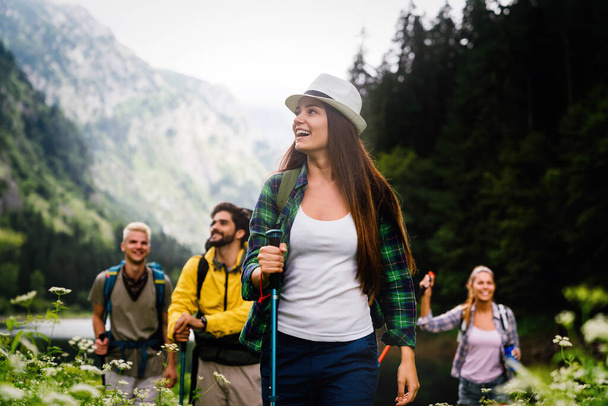 Group of happy friends, people with backpacks hiking together - Photo, image