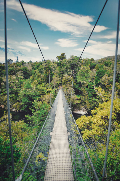 A high-angle view of a steel bridge in the mountains on a cloudy day - Photo, image