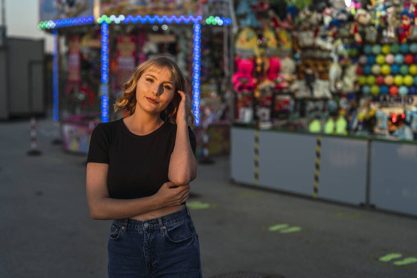 A young Caucasian female spending time at a beautiful amusement park - Photo, image