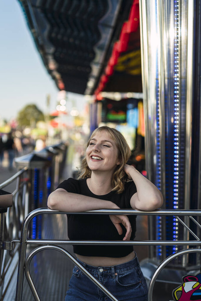A blonde Spanish female in an amusement park - 写真・画像