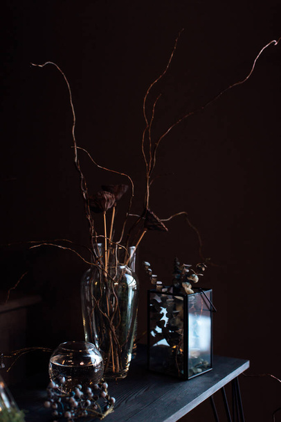 modern beautiful dark interior, room gray color, wardrobe shelves unusual gloomy decor table fabric cloth, dried flowers, vases with water, moss, branches, unusual style, halloween - Φωτογραφία, εικόνα