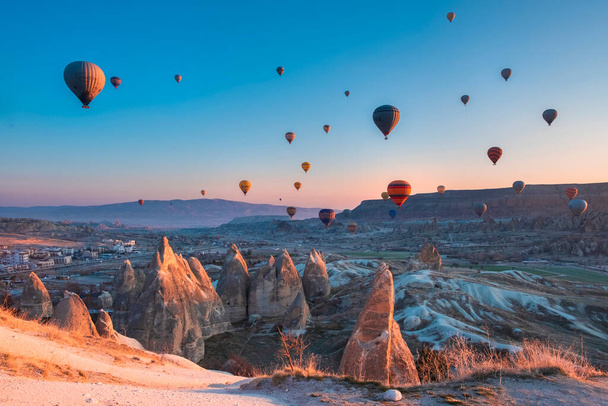 March 29, 21 Goreme Cappadocia Turkey hot air balloons fly at pink sunrise over the sandstone mountains  in the spring in the off-season - Φωτογραφία, εικόνα