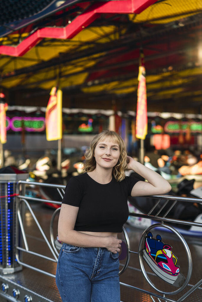 A blonde Spanish female in an amusement park - Photo, Image