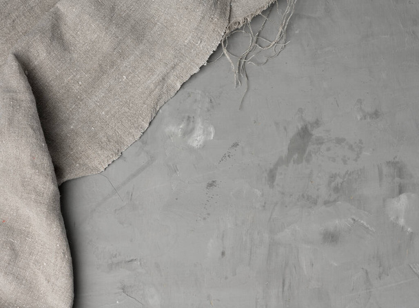 linen kitchen gray towel on gray cement background, copy space, top view - Foto, Imagem