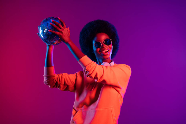 Photo of excited dj girl open mouth hold disco ball wear sweatshirt earphones specs isolated gradient neon background - Φωτογραφία, εικόνα