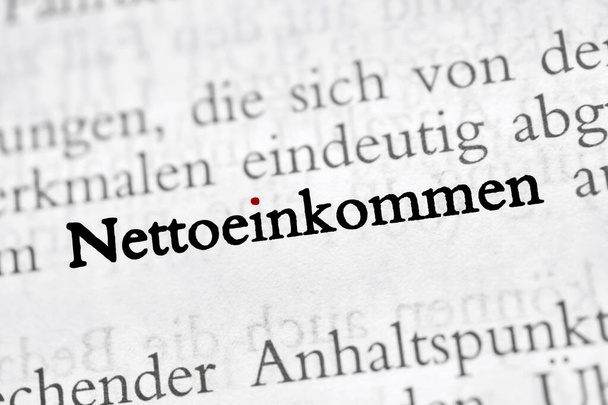 Nettoeinkommen is the German word for net income - black and white text, red dot on the i  - Photo, Image