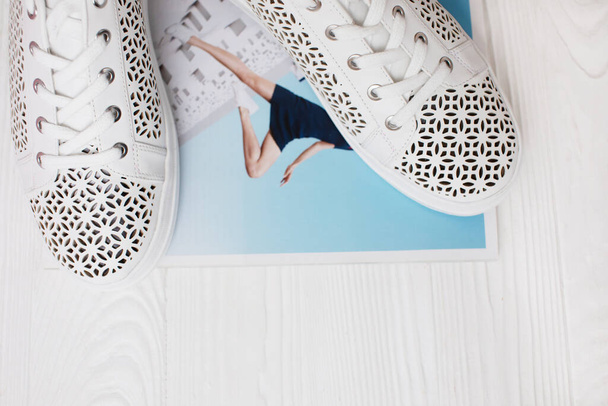 top view of stylish white sneakers on wooden background - Foto, immagini