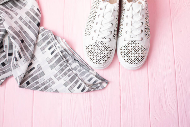 top view of stylish white sneakers on pink wooden background  - Photo, image