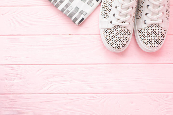 top view of stylish white sneakers on pink wooden background - Foto, immagini