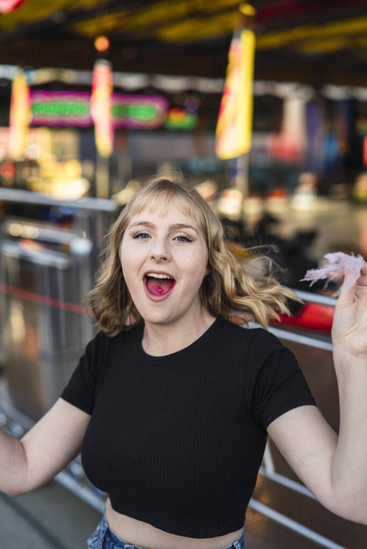 A positive young female in an amusement park - Fotoğraf, Görsel