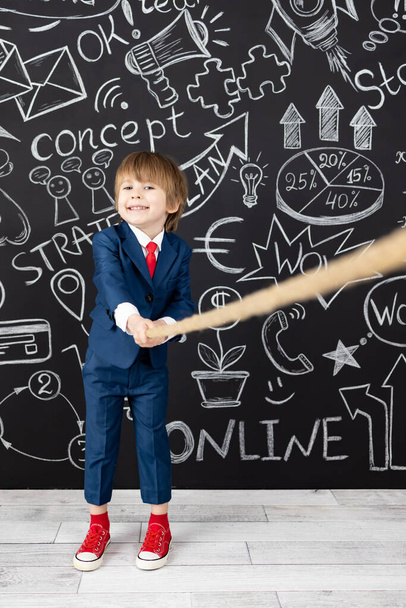 Bright idea! Funny child student in class against black chalkboard. Happy kid pretend to be businessman. Online education and e-learning concept. Back to school - Zdjęcie, obraz