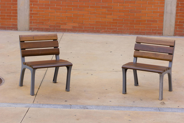 Urban chairs in public space; empty chairs on gray urban ground. Minimalism to rest. - Photo, Image