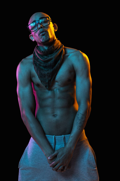 African-american young mans portrait on black studio background in neon. Concept of fashion, mans beauty, youth culture, performance. - Fotografie, Obrázek