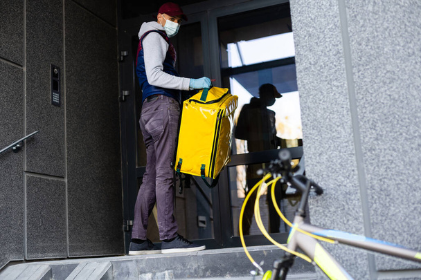 Young delivery man with yellow backpack takeaway concept - Photo, Image