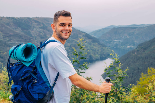 young man outdoors hiking with natural landscape - Foto, immagini