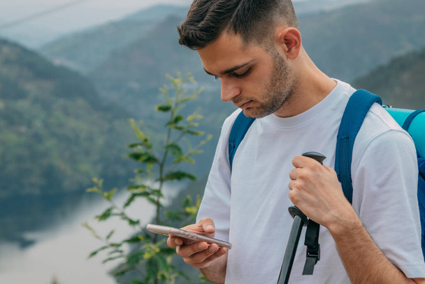 traveler man with mobile phone in nature - Photo, Image
