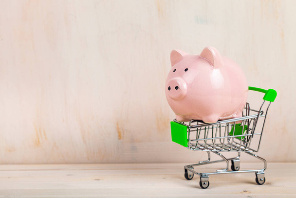 Pig piggy bank in a shopping cart. Money accumulation concept. - Photo, image