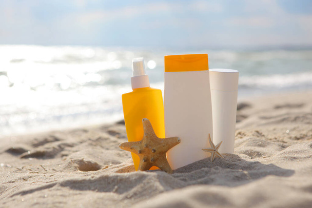 Sunscreens on the beach near the sea close up - Photo, Image