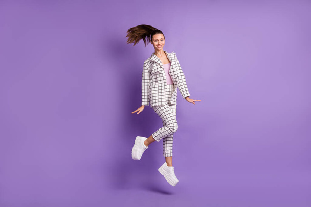 Full length photo of young woman happy positive smile have fun jump up wear suit isolated over violet color background - Fotó, kép