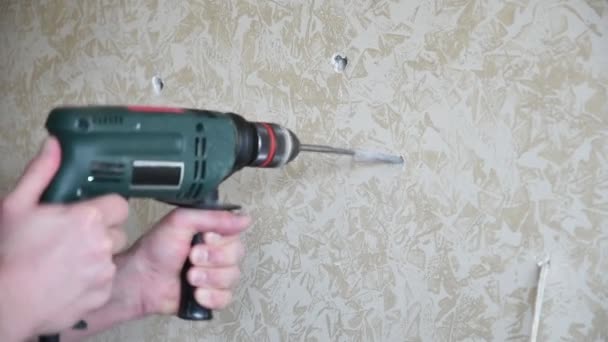 Man hands work with perforator to make hole in plaster wall. Home improvement. Slow motion - Footage, Video