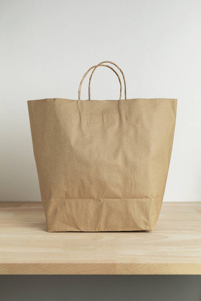 brown paper bag on wooden table for mockup blank template - Fotografie, Obrázek