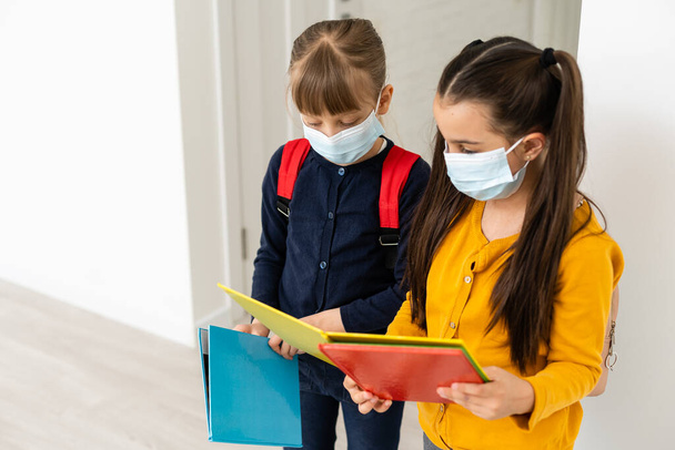 Close-up portrait of two nice attractive girls wearing safety mask. stop influenza disease pandemia - Photo, Image