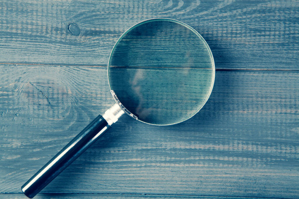 magnifying glass on gray wooden background - Photo, Image
