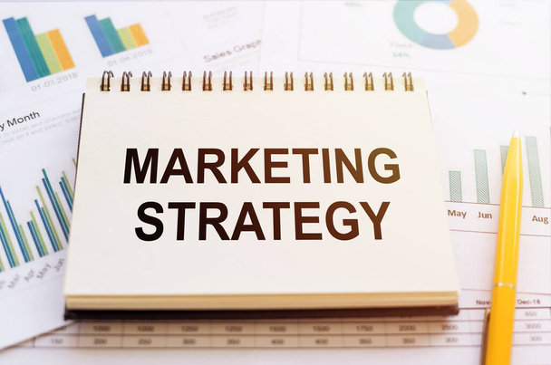Marketing Strategy - written on notepad on financial charts and graphs with yellow pen. - Fotoğraf, Görsel