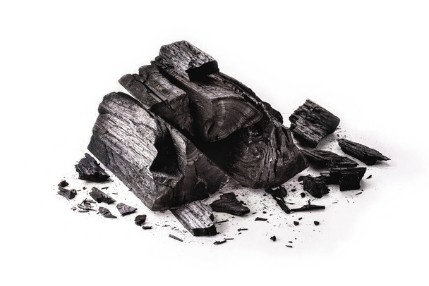 pile of charcoal, burnt pieces of coal, with space for text on white background - Photo, image