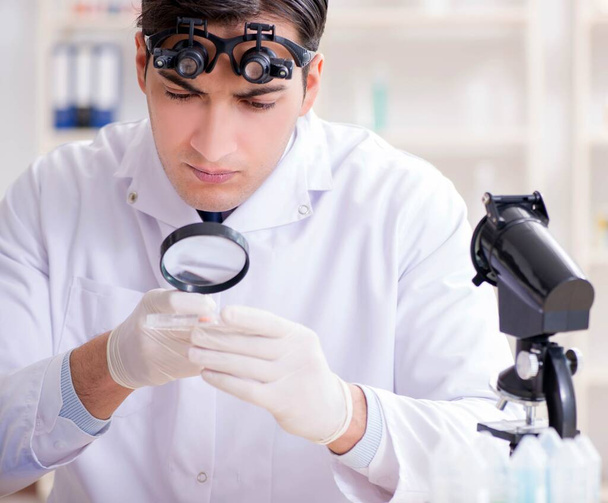 Young chemical scientist working in lab - Фото, зображення