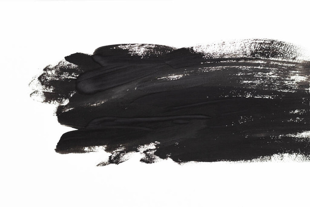 A black watercolor spot. A blot of paint on a white background - Zdjęcie, obraz