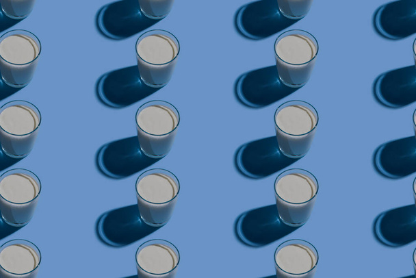 World Milk Day. Pattern on a blue background. A glass of milk. Pattern. - Foto, immagini