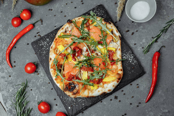 Leckere Pizza mit Lachs und Gemüse. Italienische Pizza. - Foto, Bild