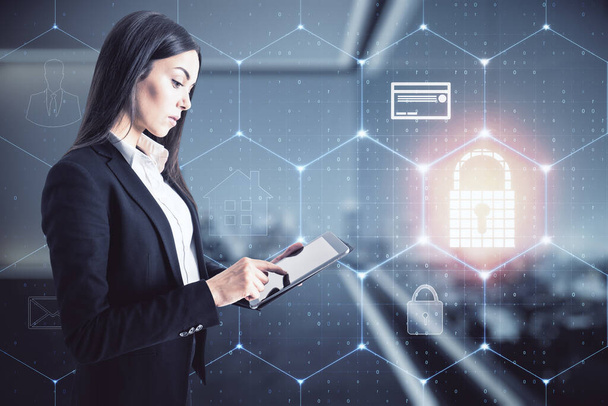 Businesswoman standing with a mobile phone in an office with a keylock hologram, data safety and cybersecurity concept - Φωτογραφία, εικόνα