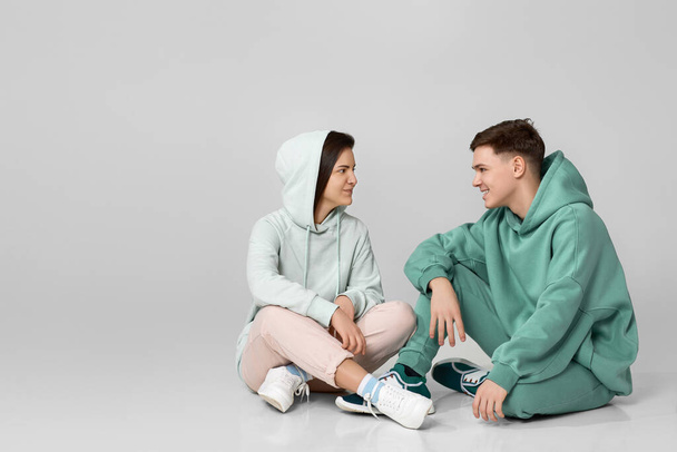 young couple wearing mint green casual hoodie - Foto, Imagem
