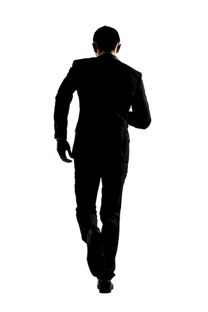 Silhouette of business man running - Foto, afbeelding
