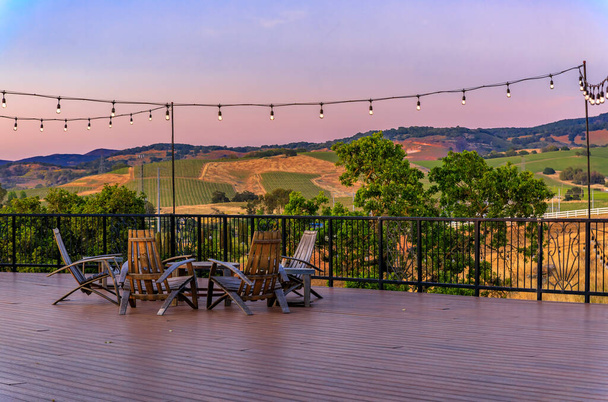 Outdoor table with chairs on a wooden deck in the spring in Napa Valley, California USA - Photo, Image