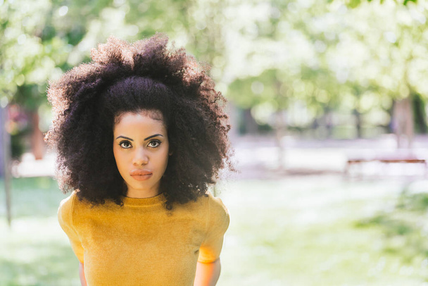 Portrait of nice afro girl in a garden. Close up. - Photo, Image