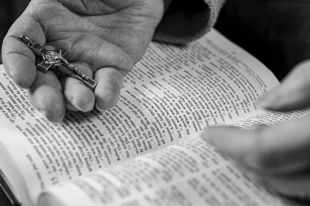 hands of elderly woman pray on bible - Photo, Image
