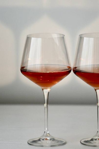 Glasses with red wine in a white interior - Photo, image
