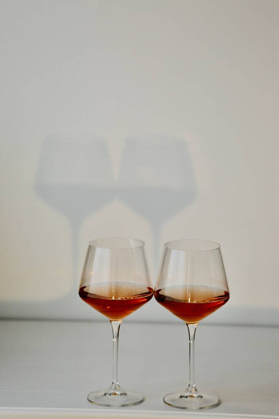 two glasses of champagne are standing in a beautiful interior  - 写真・画像