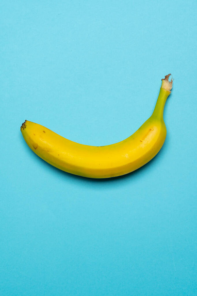 Still life stock photo of ripe yellow banana on coloured background - Foto, imagen