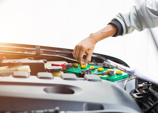 Automobilový mechanik opravář kontroluje automobilový motor s kontrolou zápisu do schránky kontrolní seznam pro opravy strojů, autoservis a údržbu. - Fotografie, Obrázek